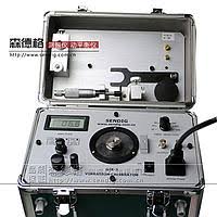 Technician checking a vibration calibration device in an inspection service environment