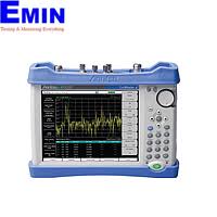 Technician reviewing a telecom analyzer used for base station testing